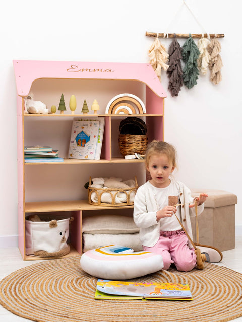 pink child-sized wooden doll house bookcase for nursery