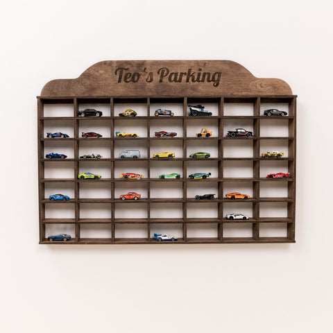 Wooden wall shelf with 'Teo's Parking' sign, displaying various model cars.