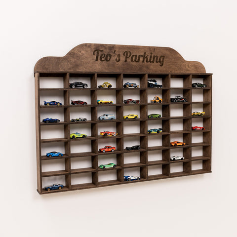 Wooden toy car parking garage with multiple toy cars on a white background